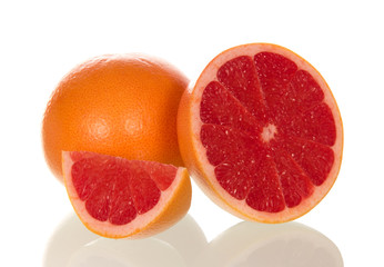 Fototapeta na wymiar Grapefruit and juicy slice isolated on white
