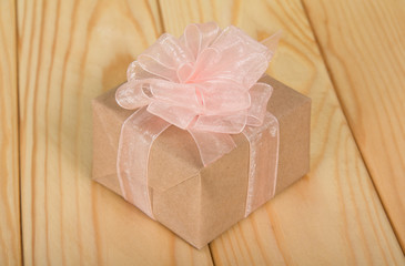 Gift box with a bow on a table