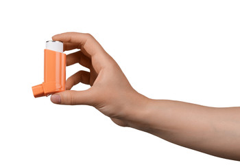 Small inhaler in a female hand, isolated on white