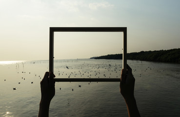 Hands holding an empty frame border