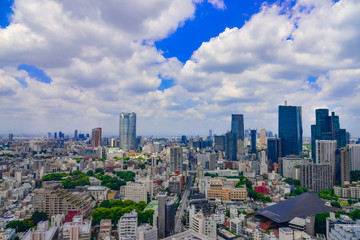 Fototapeta premium Beautiful city skyline of Downtown Tokyo, Among crowded skyscrapers under blue sunny sky in Tokyo, Japan. Aerial view of busy Tokyo City. 10 October 2017