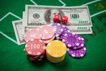Poker chips and banknotes on table in casino