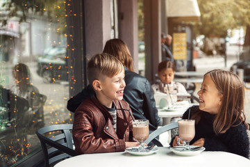 Children having fun in outdoor cafe