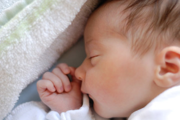 Newborn baby girl in hostpital bed sleeping