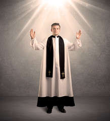 young priest in giving his blessing