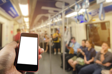 hand using mobile phone with blank screen with blurred view of people in train at train station, internet, social media technology and network connection concept