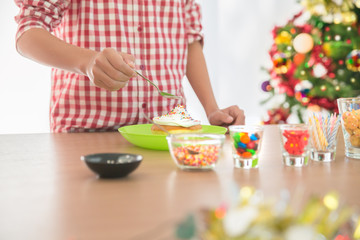 Man hand making and decorated cup cake with sugar and chocolate preparing for Christmas feast celebration