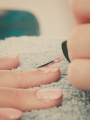 Obraz na płótnie Canvas Woman in beauty salon getting manicure done.