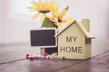 Real Estate and future home concept,small wooden house and signage for text