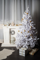 A beautifully decorated room with a fireplace and a Christmas tree for Christmas and a New Year in white. Winter card.