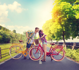 Obraz premium Young man and woman, romantic date on bicycles