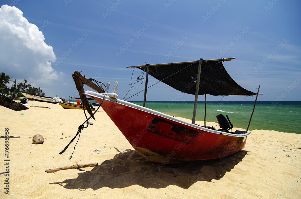 Wall mural beautiful scenery, traditional fisherman boat moored over beautiful sea view and sandy beach under b