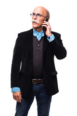 Fototapeta premium Mature handsome man talking on his cellphone against a white background