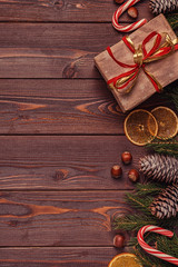 Christmas gift boxes and fir tree  on wooden background.