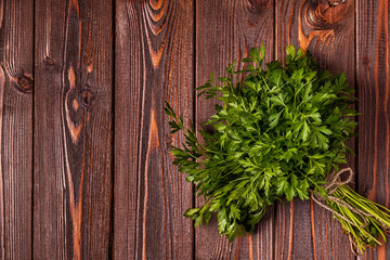 Bunch of parsley  on a wooden background.