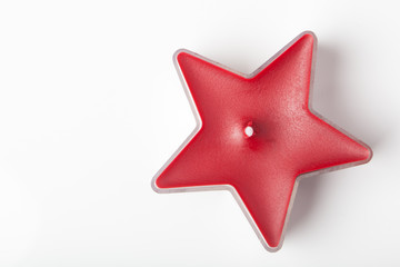 Candle in red star form, isolated on white
