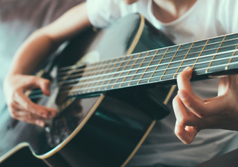 Fototapeta premium Little girl playing the guitar.