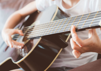 Little girl playing the guitar.