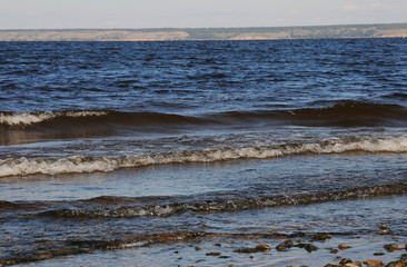 Waves near a stony shore close up