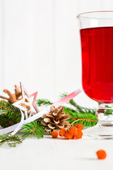 A glass of red hot mulled wine on a light background. Christmas and New Year greeting card.