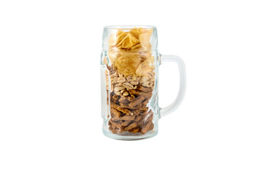 Different salty snacks in beer glass. Isolated on white.