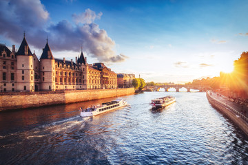 Dramatic sunset over Cite in Paris, France, with Conciergerie, Pont Neuf and river Seine. Colourful travel background. Romantic cityscape.