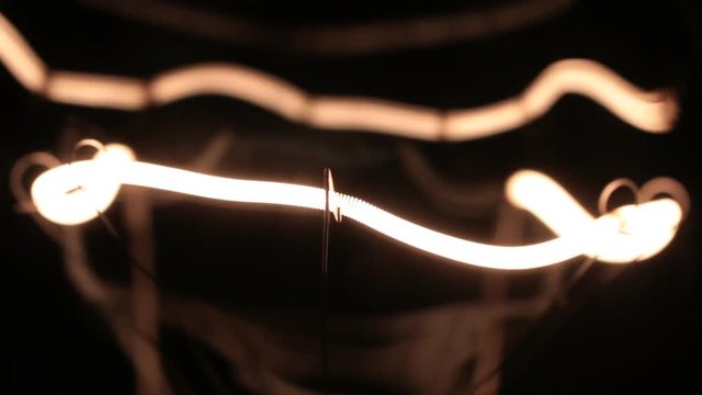 Smooth increase and decrease in the power of the helix of the tungsten filament. Close-up