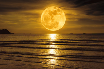 Super moon. Colorful sky with cloud and bright full moon over seascape.