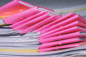 Stack of tutorial paper sheets for an examination and selective focus of pink document corners