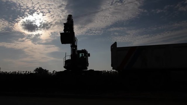 Excavator and track silhouette. Mechanical shovel at work