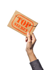 Envelope with stamp top secret in the human hand.  Isolated on white background.