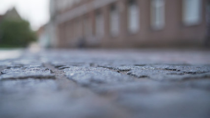 low angle closeup background of old pavement in tallinn with blurred background