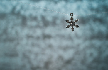 Beautiful metal toys on a niche in the background of a frozen window with beautiful patterns