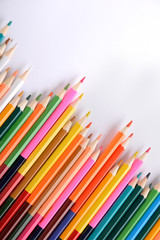 Fototapeta premium Colored crayons background. Many different colored pencils on white background