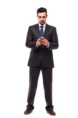Fototapeta premium Young business man typing message on smartphone touch screen.