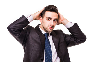 serious young businessman standing with hands crossed isolated on white