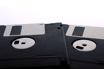 Detail of black floppy disks isolated on white background (back side)