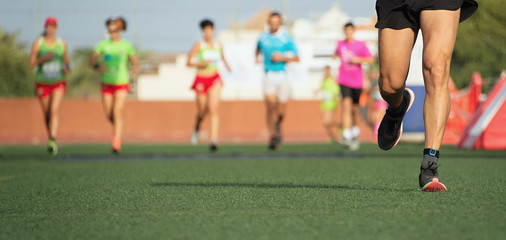 Fototapeta premium Marathon running race, people feet on the lawn