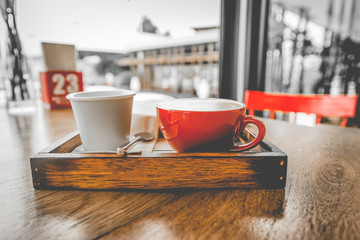 Red coffee cup on wooden table