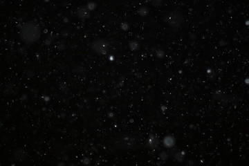 Fototapeta na wymiar snow on a black background texture overlay bokeh highlights