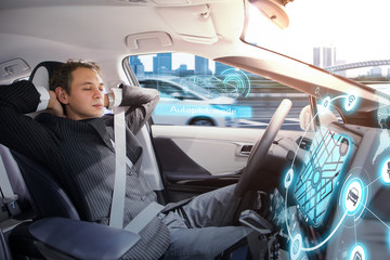 Caucasian man sleeping in autonomous car. Self driving vehicle. Driverless car.