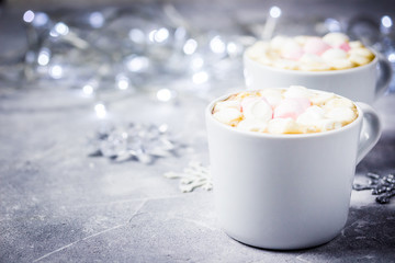 Christmas festive hot chocolate marshmallow drink, lights, snowflakes. Selective focus, space for text, close up. 