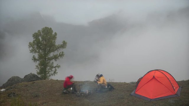 Tourist tent in camp in the mountains in fog. Time lapse