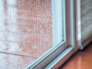 Rainy day, drops on door mirror, wet floor and room.