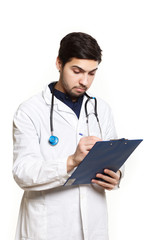 beautiful young doctor in a dressing gown with a stethoscope on a white background in the studio