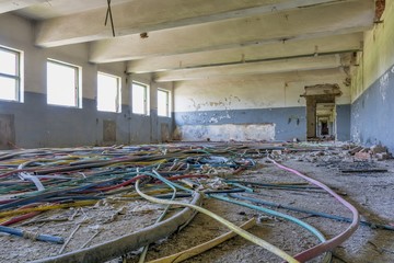 Abandoned factory industrial interior. Inside the ruins of an old factory  in Romania of a Communist Era. Step inside of abandoned old factory in eastern Europe.