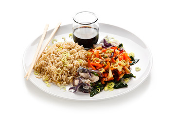 Rice dish with goulash on white background 