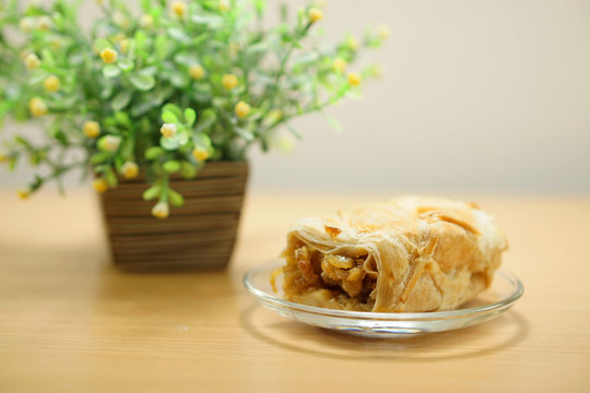 A Piece Of Mix Fruit Pie On A Glass Plate On Wood Table.