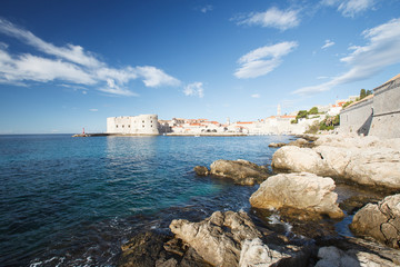 Fototapeta na wymiar View of the fortress of St. John and the lighthouse from the stony beach. Dubrovnik, Croatia