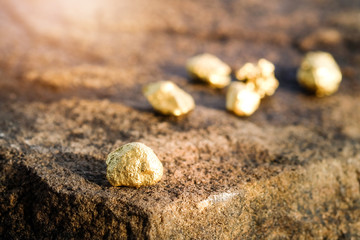 The pure gold ore found in the mine on a stone floor